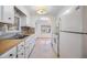Kitchen with white cabinets, wood countertops, and appliances at 4711 Olive Dr, Zephyrhills, FL 33542