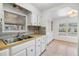 Kitchen with white cabinets, wood countertops, and tile floor at 4711 Olive Dr, Zephyrhills, FL 33542