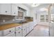 Kitchen with white cabinets, wood countertops, and appliances at 4711 Olive Dr, Zephyrhills, FL 33542