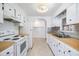 Kitchen with white cabinets, wood countertops, and appliances at 4711 Olive Dr, Zephyrhills, FL 33542