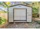 Large metal storage shed with roll-up door at 4711 Olive Dr, Zephyrhills, FL 33542