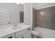 Bathroom with grey tile, a shower/tub combo, and white vanity at 5658 Del Coronado Dr, Apollo Beach, FL 33572