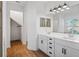 Double vanity bathroom with white cabinets and quartz countertops at 5658 Del Coronado Dr, Apollo Beach, FL 33572