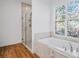 Bathroom with a soaking tub, glass shower, and stained glass window at 5658 Del Coronado Dr, Apollo Beach, FL 33572