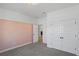 Bedroom with pink accent wall and double doors at 5658 Del Coronado Dr, Apollo Beach, FL 33572