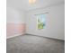 Bedroom with pink accent wall and grey carpet at 5658 Del Coronado Dr, Apollo Beach, FL 33572