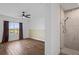 Bright bedroom with wood floors, large window, and ceiling fan at 5658 Del Coronado Dr, Apollo Beach, FL 33572