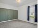 Bedroom with green accent wall and grey carpet at 5658 Del Coronado Dr, Apollo Beach, FL 33572