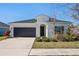 Single-story home with dark gray garage door and landscaped yard at 5658 Del Coronado Dr, Apollo Beach, FL 33572