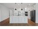 Large kitchen island with white cabinets and quartz countertops at 5658 Del Coronado Dr, Apollo Beach, FL 33572