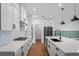 Modern kitchen with white cabinets, quartz countertops and stainless steel appliances at 5658 Del Coronado Dr, Apollo Beach, FL 33572