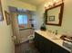 Elegant bathroom with walk-in shower and dark vanity at 5730 16Th Ne Ln, St Petersburg, FL 33703