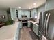 Updated kitchen with stainless steel appliances and light teal cabinets at 5730 16Th Ne Ln, St Petersburg, FL 33703