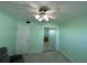 Light green bedroom with tile floors, mirrored closet doors, and ceiling fan at 5895 18Th N St # 9, St Petersburg, FL 33714