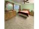 Bedroom with tiled floors and wood furniture at 5895 18Th N St # 9, St Petersburg, FL 33714