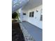 Exterior view of condo building, showing walkway, landscaping, and building exterior at 5895 18Th N St # 9, St Petersburg, FL 33714