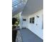 Exterior view of condo building, showing walkway, landscaping, and building exterior at 5895 18Th N St # 9, St Petersburg, FL 33714