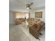 Living room with tiled floor, sofas, coffee table, and ceiling fan at 5895 18Th N St # 9, St Petersburg, FL 33714