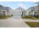 Two-story Craftsman home with gray siding, white accents, and a two-car garage at 5936 Golden Nettle Dr, Apollo Beach, FL 33572