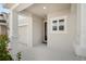 Covered front porch with a view of the garage and walkway at 5936 Golden Nettle Dr, Apollo Beach, FL 33572