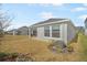 Single-story home with backyard, grassy area, and covered patio at 5936 Golden Nettle Dr, Apollo Beach, FL 33572
