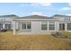Back exterior view showing covered patio and yard at 5936 Golden Nettle Dr, Apollo Beach, FL 33572