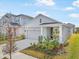 One-story home with a gray exterior, two-car garage, and landscaping at 5936 Golden Nettle Dr, Apollo Beach, FL 33572