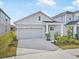 Craftsman-style house with a two-car garage and well-manicured landscaping at 5936 Golden Nettle Dr, Apollo Beach, FL 33572