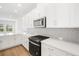 Modern kitchen with white cabinets, stainless steel appliances and island at 5936 Golden Nettle Dr, Apollo Beach, FL 33572
