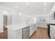 Bright kitchen with white cabinetry, large island, and hardwood floors at 5936 Golden Nettle Dr, Apollo Beach, FL 33572