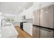 Modern kitchen with white cabinets, stainless steel appliances, and herringbone backsplash at 5936 Golden Nettle Dr, Apollo Beach, FL 33572