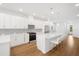 Modern kitchen island with white quartz countertop and gold barstools at 5936 Golden Nettle Dr, Apollo Beach, FL 33572