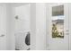 Laundry room with Whirlpool washer and dryer, and a view of backyard at 5936 Golden Nettle Dr, Apollo Beach, FL 33572