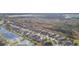 Property aerial view highlighting its position next to a lake and expansive natural area at 6722 Boulder Run Loop, Wesley Chapel, FL 33545