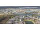 Extensive aerial view showcasing the neighborhood with water features and lush green spaces at 6722 Boulder Run Loop, Wesley Chapel, FL 33545