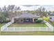 Aerial view of a fenced backyard with a screened lanai and well-maintained lawn at 6722 Boulder Run Loop, Wesley Chapel, FL 33545