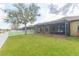 Well-maintained backyard featuring a screened lanai and a white picket fence at 6722 Boulder Run Loop, Wesley Chapel, FL 33545