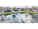 Scenic backyard view with a serene pond reflecting the sky and surrounding homes at 6722 Boulder Run Loop, Wesley Chapel, FL 33545