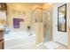 Well-lit bathroom with a tub, clear glass shower, neutral walls, and a functional design at 6722 Boulder Run Loop, Wesley Chapel, FL 33545