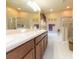 Bathroom featuring double sinks, a soaking tub and a separate glass shower enclosure at 6722 Boulder Run Loop, Wesley Chapel, FL 33545