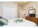 Comfortable bedroom features a closet, dresser with mirror, and a neutral color scheme at 6722 Boulder Run Loop, Wesley Chapel, FL 33545