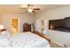 Spacious bedroom with a ceiling fan, a wooden bed frame and TV mounted on the wall at 6722 Boulder Run Loop, Wesley Chapel, FL 33545