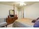 Comfortable bedroom featuring a four poster bed and wooden dresser at 6722 Boulder Run Loop, Wesley Chapel, FL 33545