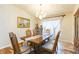 Formal dining room with hardwood floors, bright natural light, a traditional chandelier, and elegant decor at 6722 Boulder Run Loop, Wesley Chapel, FL 33545