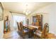 Elegant dining room featuring hardwood floors, a chandelier, decorative accents, and natural light from the window at 6722 Boulder Run Loop, Wesley Chapel, FL 33545