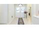 Bright foyer featuring tile flooring, a decorative rug, and an elegant double-door entrance with transom window at 6722 Boulder Run Loop, Wesley Chapel, FL 33545