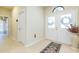 Welcoming foyer featuring tile flooring, decorative rug and a view of the double-door front entrance with transom window at 6722 Boulder Run Loop, Wesley Chapel, FL 33545