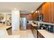 Spacious kitchen with stainless steel appliances and dark wood cabinets at 6722 Boulder Run Loop, Wesley Chapel, FL 33545