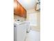 Functional laundry area featuring overhead storage cabinets and laundry machines at 6722 Boulder Run Loop, Wesley Chapel, FL 33545