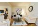 Cozy living room featuring hardwood floors, stylish furnishings, tasteful decor, and ample natural light at 6722 Boulder Run Loop, Wesley Chapel, FL 33545